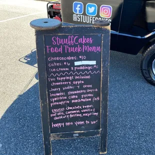 a chalkboard sign in front of a truck