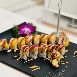 a sushi roll on a black plate