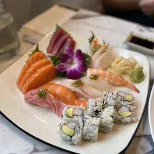 a plate of sushi and a glass of water