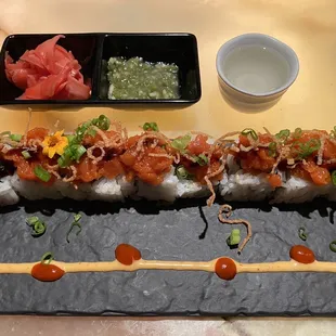 a sushi roll on a slate platter
