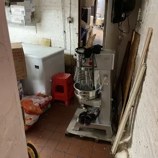 a kitchen with a mixer in the corner