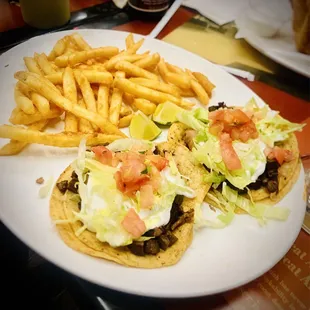 Two steak tacos and fries