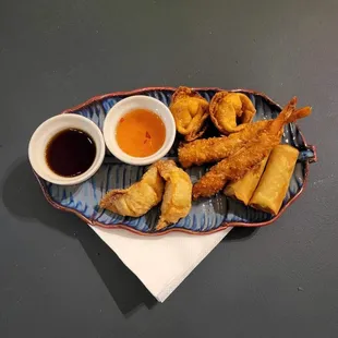 a plate of fried food with dipping sauce