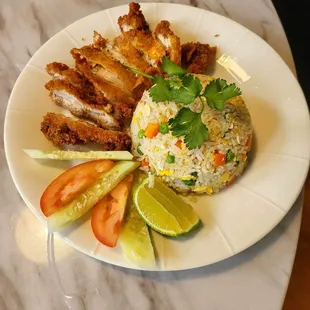 a plate of rice, meat, and vegetables