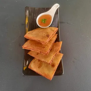 a plate of crackers with dipping sauce