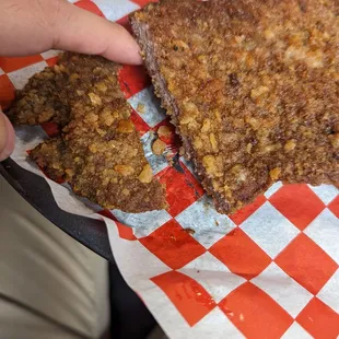 a person holding a piece of food