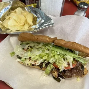 Cheesesteak and chips. Made with ribeye steak