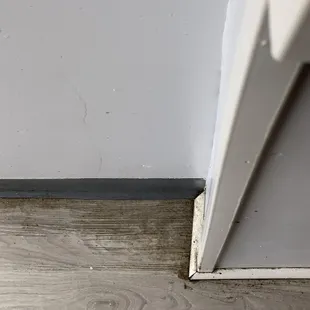 the corner of a room with wood flooring