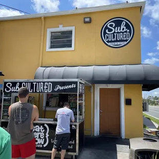 a group of people standing outside of a store