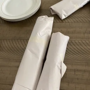 a plate, napkins, and plates on a table