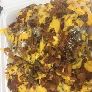 a tray of loaded fries with cheese and bacon