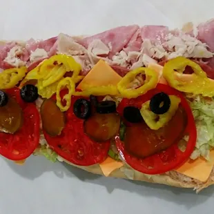 The American Supreme!  A generous amount of meat:  Ham, turkey, Bologna, and American yellow cheese Topped with all your favorite vegetables