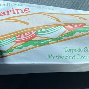 a sub sandwich wrapped in white paper