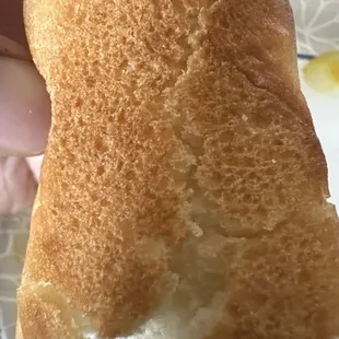 Non-toasted bread that is hard and likely stale.