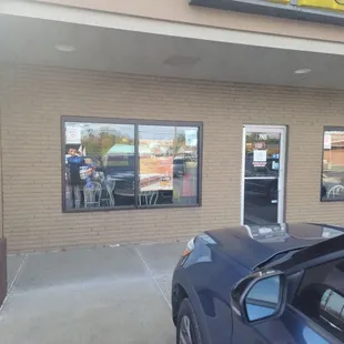a car parked in front of a sub station