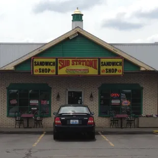 a car parked in front of a sub station