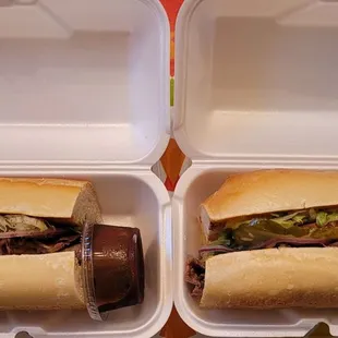 two subs in a styrofoam container