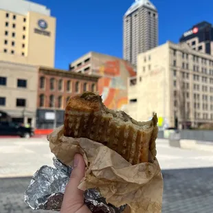 a hand holding a piece of food