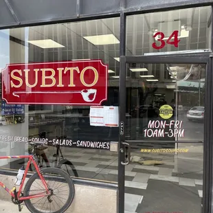 a bicycle parked in front of a store
