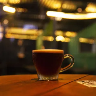 a cup of coffee on a wooden table