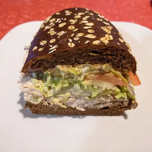 Half of a medium tuna sub on squaw bread.