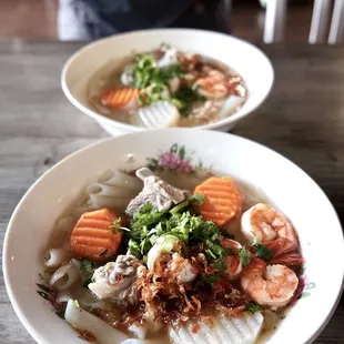 two bowls of seafood and rice soup