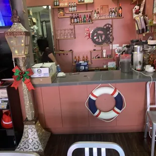 a pink bar with a life preserver on the counter