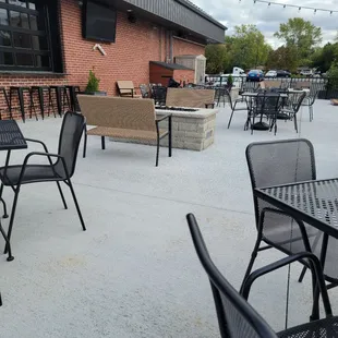 a patio with tables and chairs