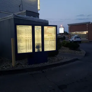 a bus stop with a menu on it