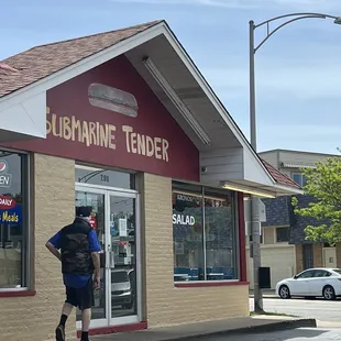 two people walking out of the building