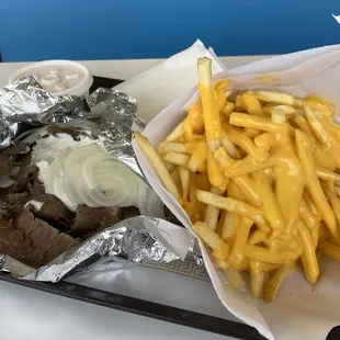 Gyros and cheese fries.  Extra cheese cup for the gyros.  You will have to eat your way down to the sandwich.