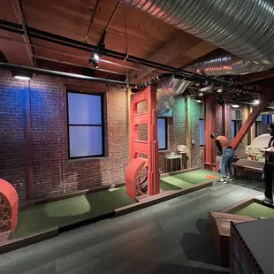 two people playing mini golf