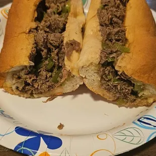 a sub sandwich on a paper plate