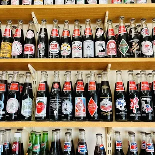 a shelf full of soda bottles