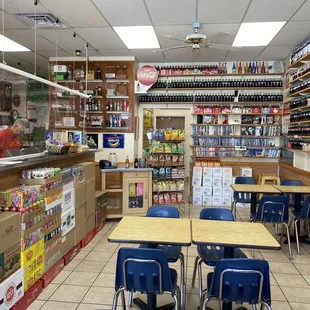 a grocery store with tables and chairs