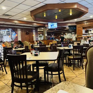 people sitting at tables in a restaurant