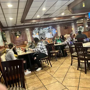 people sitting at tables in a restaurant
