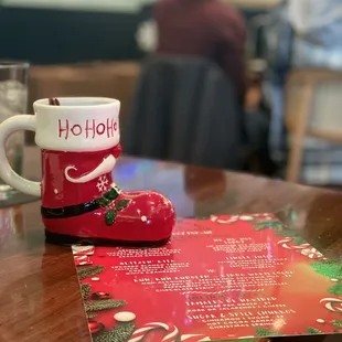 a red boot and a christmas card on a table