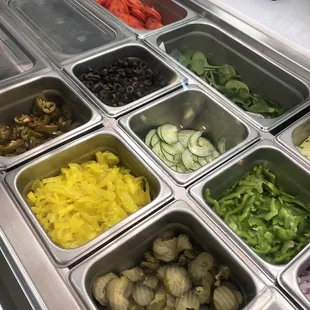 a variety of vegetables in trays