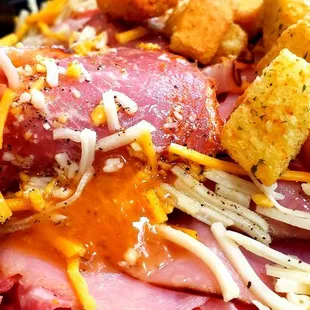 a plate of ham, cheese, and bread