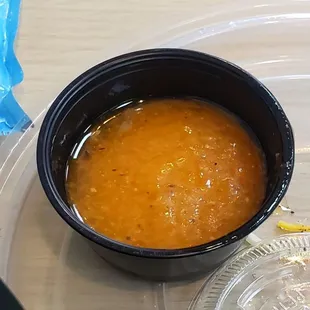 a bowl of soup and a bag of chips