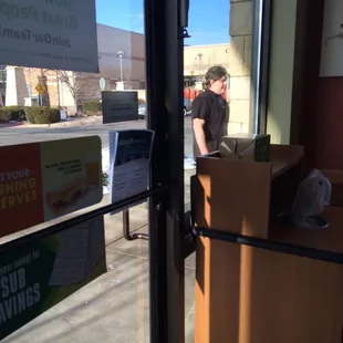 Employee smoking cigarettes next to the front door.  Guess what? He didn&apos;t wash his hands before returning to work.