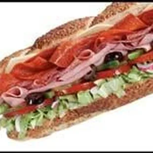 a sub sandwich with meat, lettuce, tomatoes, and olives