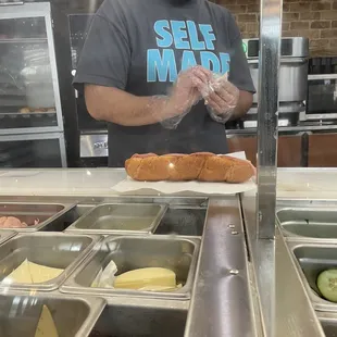 a man preparing food in a subway