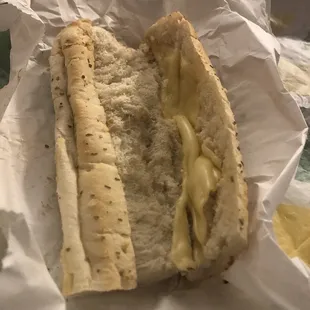 a hot dog with cheese on a bun
