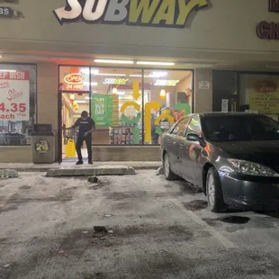 a woman walking out of a subway