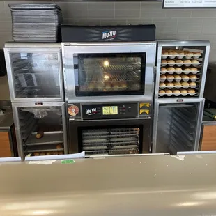 a counter with a bunch of ovens