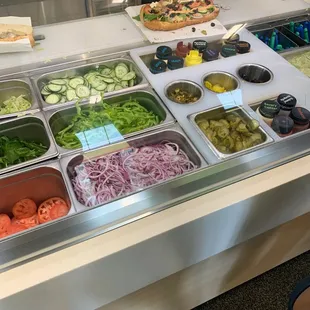 a salad bar with a variety of vegetables