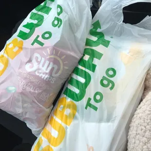 two bags of food in the back of a car