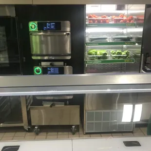 a view of a subway kitchen with a variety of food items